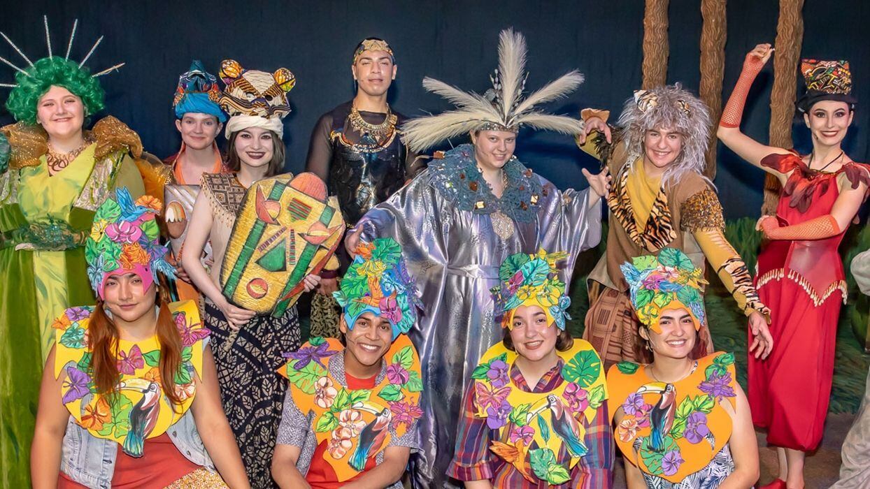 The cast of “Anansi’s Carnival Adventure” posing in their colorful costumes and masks.