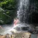 Student under waterfall in Costa Rica
